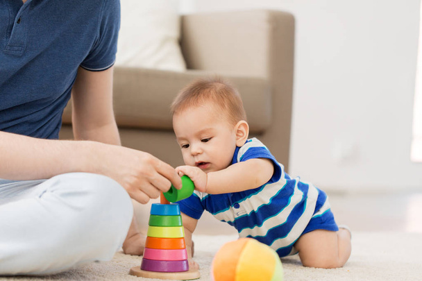 baby boy with father and pyramid toy at home - Φωτογραφία, εικόνα