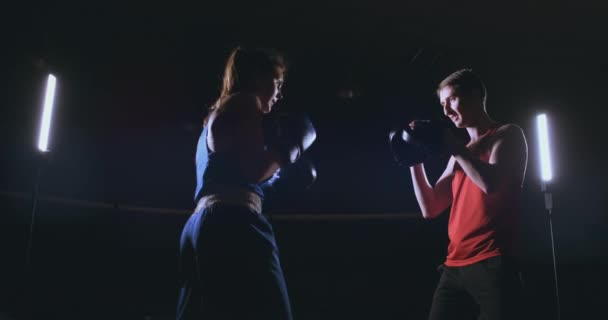 fitness woman athlete boxing punching focus mitts enjoying intense exercise female fighter training friend in gym workout together slow motion - Footage, Video