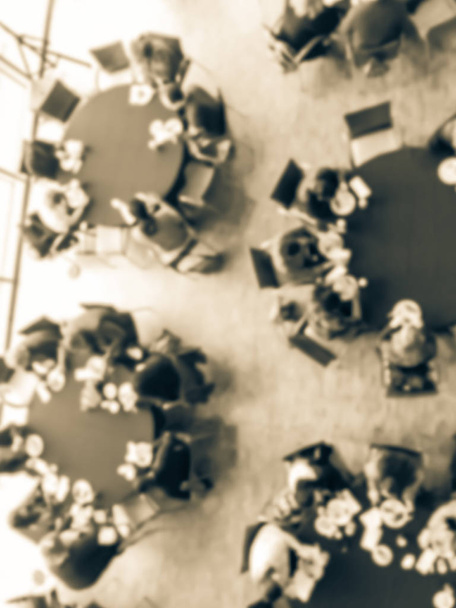 Φιλτραρισμένη τόνος θολή φόντο γεμάτο ανθρώπους στο τραπέζι στρογγυλό συμπόσιο στην επαγγελματική εκδήλωση - Φωτογραφία, εικόνα