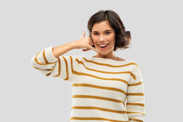 happy smiling woman showing phone call gesture - Fotoğraf, Görsel