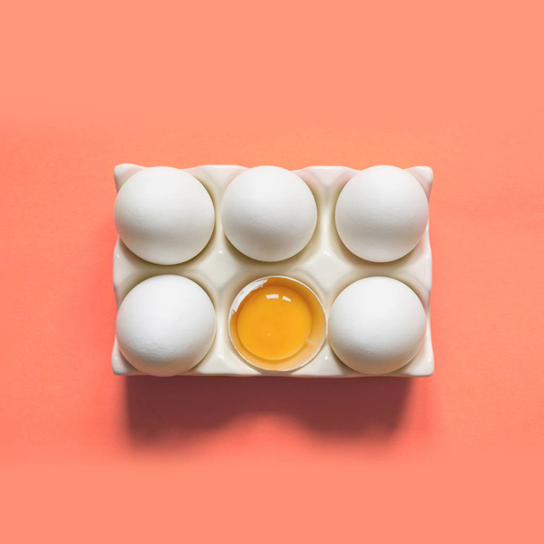 Organic white chicken eggs in porcelain decorative box on coral. Top view. - Fotó, kép