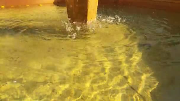 Movimiento del agua fondo amarillo en un pozo - Metraje, vídeo