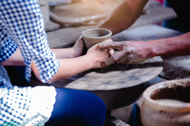 Making it together. close-up to hands of potter teacher and chil - Photo, Image