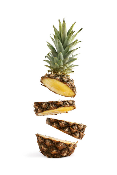 Pineapple sliced, levitates in the air. Concept of summer mood on a white background, isolate. - Photo, image