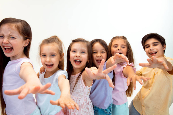 The portrait of cute little boy and girls in stylish clothes looking at camera at studio - Photo, Image