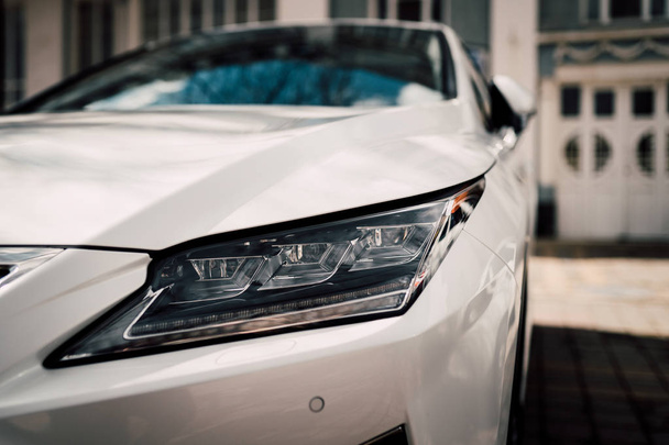 Wide angle photo of modern luxury car. Closeup view of headlamp. Elegant fantastic design - Foto, immagini