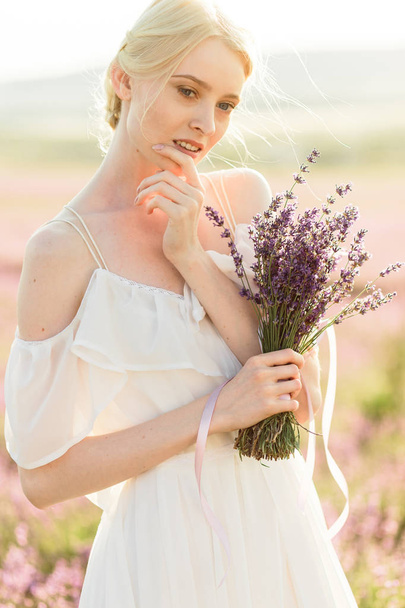 Stuning portrait of girl in light dress in lavender field on sunset - Φωτογραφία, εικόνα