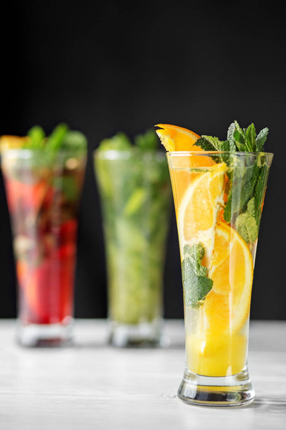 Citrus cocktail with mint in a glass goblet. Concept for drinks, summer, heat, alcohol, party and bar - Foto, Bild