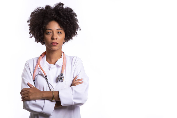 Portrait of beautiful African Brazilian doctor or nurse with arms crossed isolated over white background. - Fotó, kép