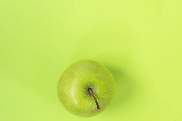 Green apple isolated on green background - Foto, Imagem