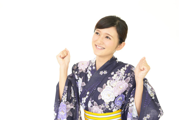 Attractive young woman wearing Japanese summer kimono - Foto, imagen