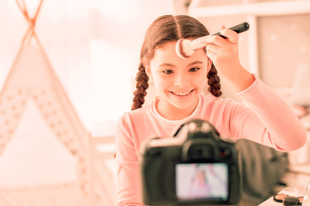 Positive nice girl holding a professional brush - Фото, изображение