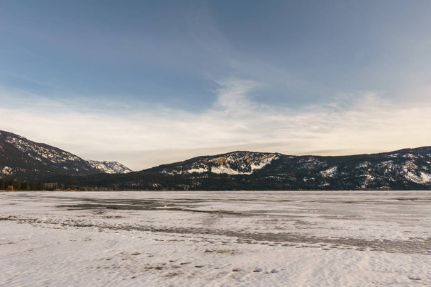 Early spring evening landscape of frozen Little Shuswap Lake British Columbia Canada. - Photo, image