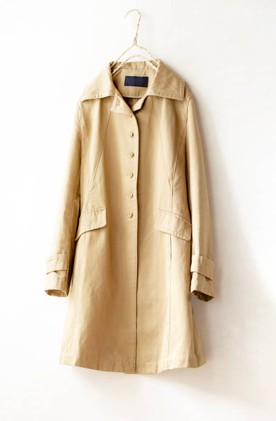 Beige elegant trench coat isolated over white - Фото, изображение