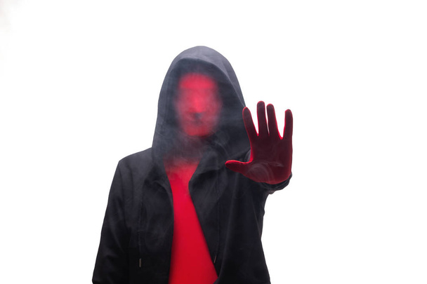 Červený muž v černé kápi a kouřový stopku. Izolované na bílém - Fotografie, Obrázek