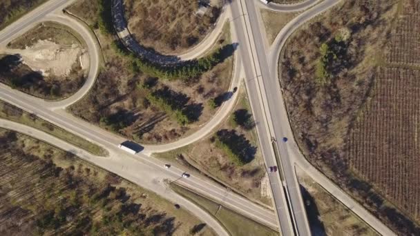 Aerial top down view of interchange road junction traffic. Drone shot flying over crossing roads and railway track. Moldova republic of. - Footage, Video