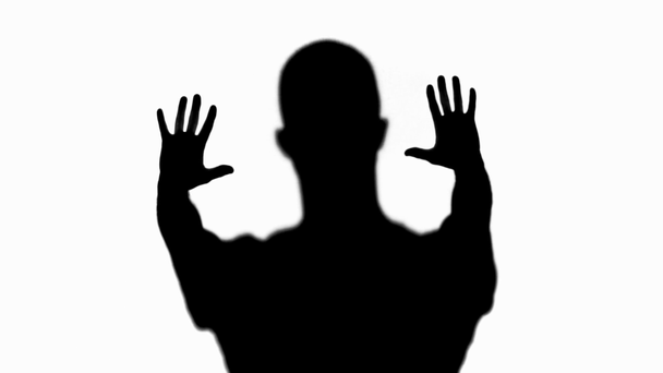 Selective focus of silhouette of man gesturing isolated on white - Footage, Video