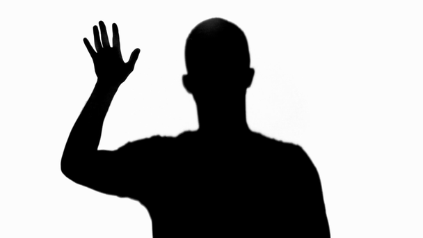 silhouette of man showing palms and slowly gesturing isolated on white - Materiał filmowy, wideo