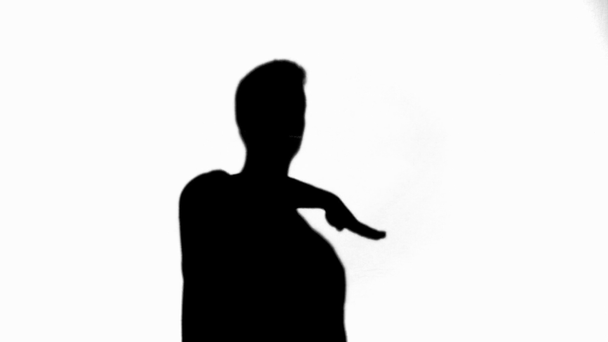 Silhouette of man moving and gesturing isolated on white - Footage, Video