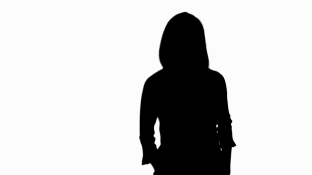 silhouette of pregnant woman moving and touching belly isolated on white - Záběry, video