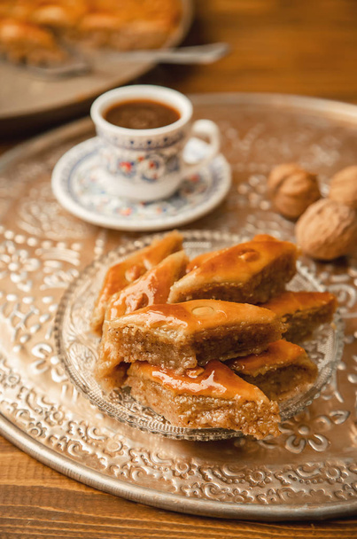 Baklava with nuts on a wooden background. Selective focus. - Photo, Image
