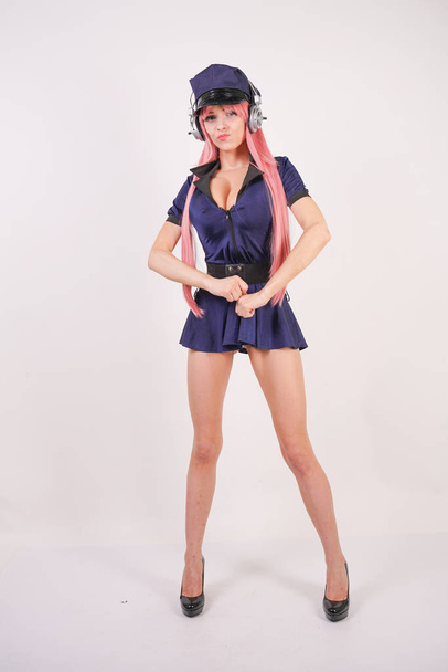 cute young girl with pink long hair in blue police uniform dress and hat with huge Breasts posing on white background in Studio - Fotoğraf, Görsel