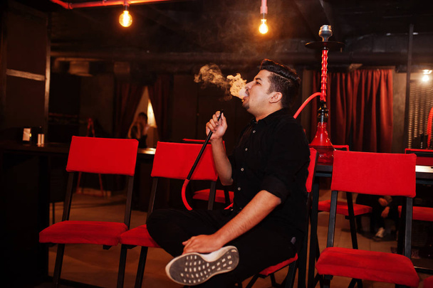 Asian man smoke hookah and having rest at lounge bar.  - Fotoğraf, Görsel