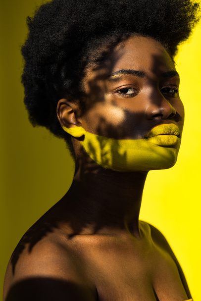beautiful african american woman with body art on yellow - Photo, Image