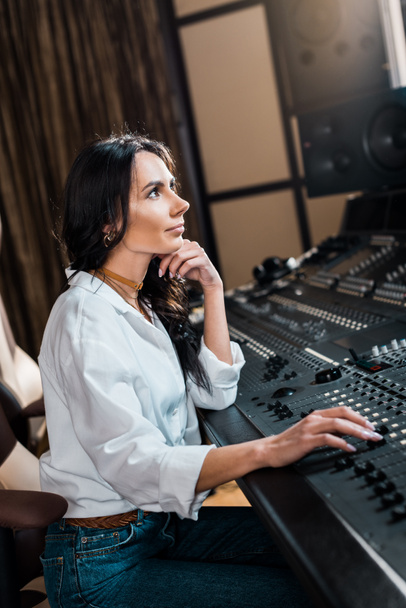 beautiful sound producer working on mixer console in recording studio - Φωτογραφία, εικόνα