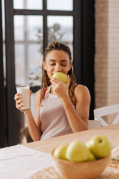 Woman loving apples feeling good while smelling green apple - Photo, image