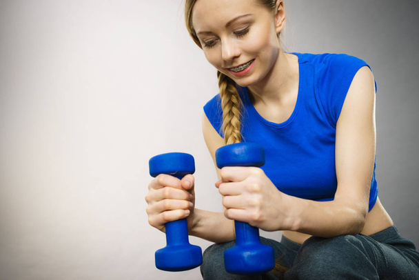 Teenage woman working out at home with dumbbell - Φωτογραφία, εικόνα