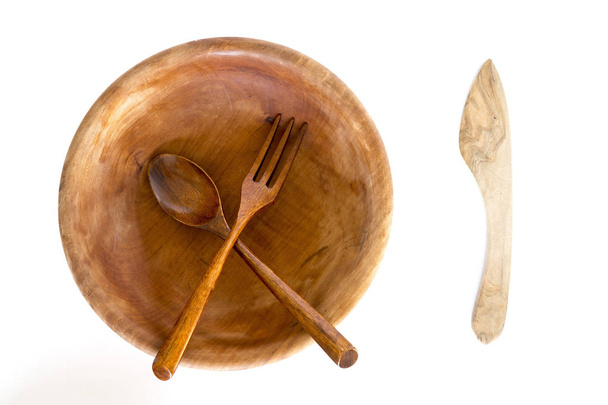 Wooden bowl with spoon, knife and fork on white background - Valokuva, kuva