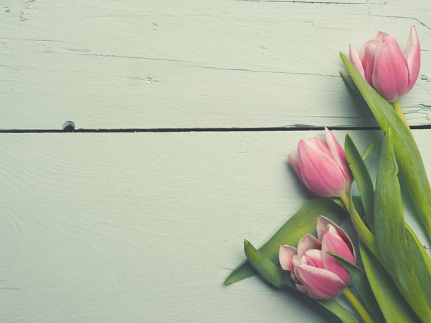 Three pink tulips on wood - Fotografie, Obrázek