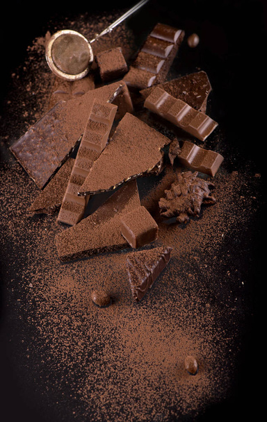chocolate pieces and cocoa powder on wooden background - Photo, Image