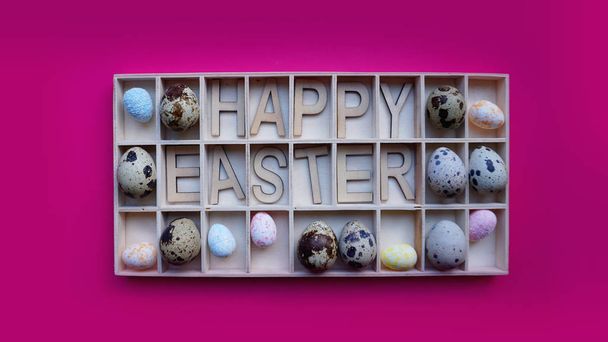 Easter eggs. Happy easter text. Holidays decoration pink background - 写真・画像