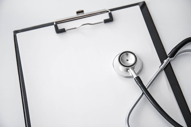 Stethoscope with clipboard on white background - Photo, Image