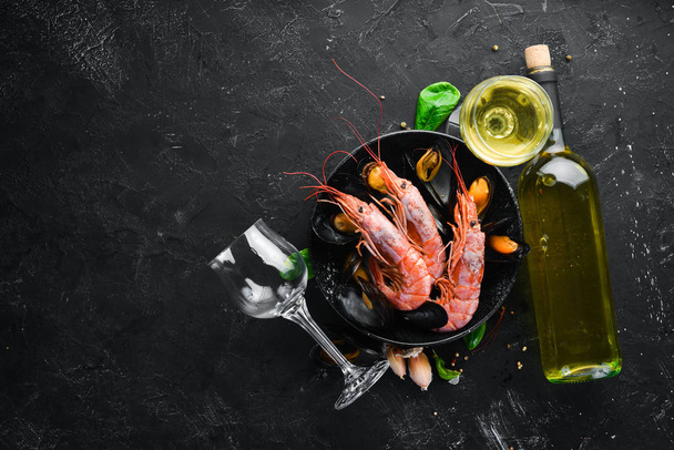 A bottle of wine and seafood. Top view. Free space for your text. On the old background. - Foto, Imagem