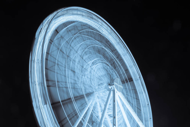 blue lights of ferris wheel at night - Photo, image