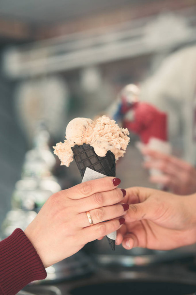 Woman buying couple scoops of  ice cream in a candy shop - Photo, Image