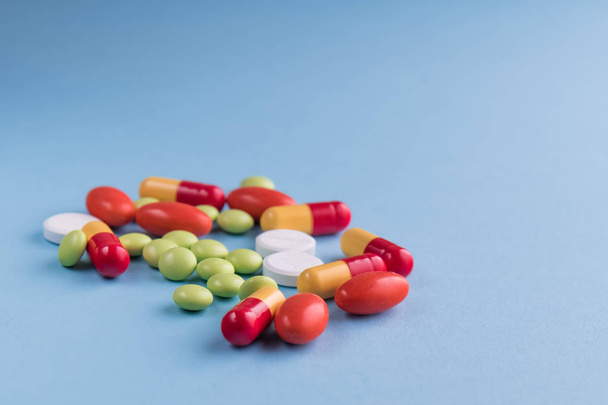 medicines and pills on blue background. - Фото, зображення