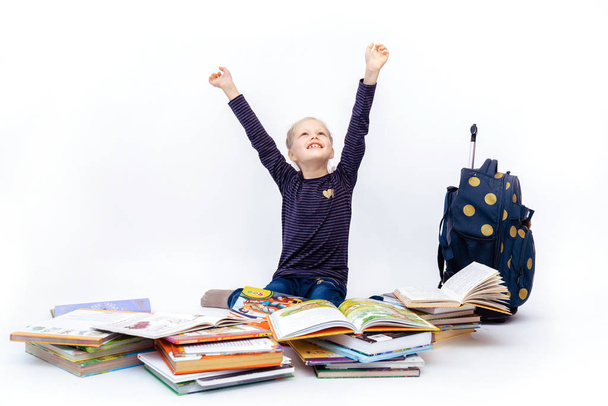 blonde girl reads books waving her arms and covers her face - Foto, immagini