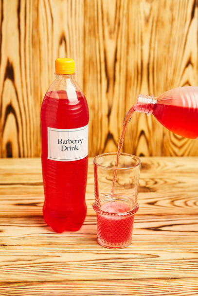 Glass full of sparking red barberry drink, homemade in Georgia, authentic recipe - Photo, Image