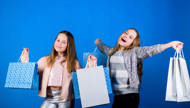Happy children in shop with bags. Shopping is best therapy. Shopping day happiness. Sisters shopping together. Buy clothes. Fashionista addicted buyer. Fashion boutique kids. Shopping of her dreams - Foto, Imagem