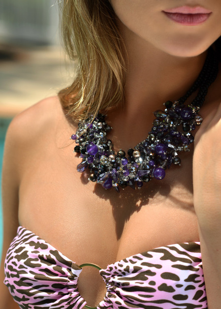 Closeup model wears semi-precious stones necklace and pink bikini - Φωτογραφία, εικόνα