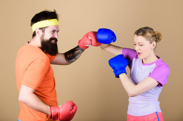 punching, sport Success. sportswear. Fight. knockout and energy. couple training in boxing gloves. Happy woman and bearded man workout in gym. training with coach. Make your competitive juices - Photo, image
