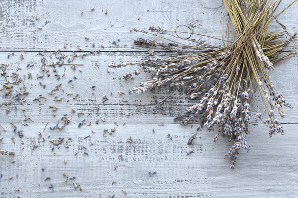 dry lavender flowers bunch on wooden background - Photo, image