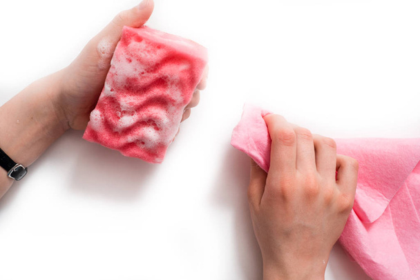 Women's hands wearing pink latex gloves for cleaning - 写真・画像