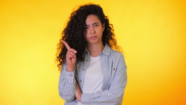 Woman disapproving with NO hand sign make negation finger gesture. Denying, rejecting, disagree, portrait of beautiful student girl or businesswoman on yellow background. - Footage, Video