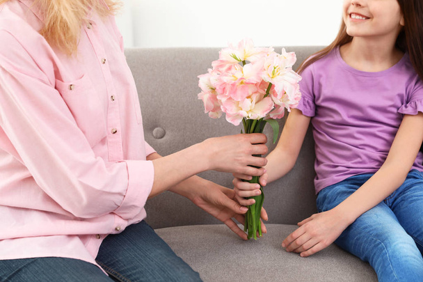 Little daughter congratulating her mature mom at home, closeup. Happy Mother's Day - 写真・画像