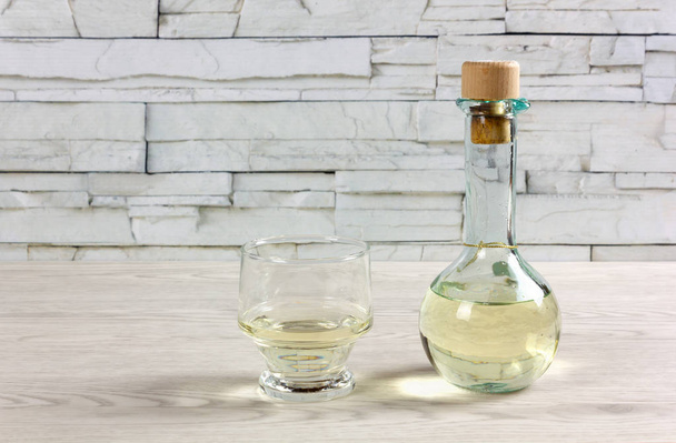 白ワインと木製のテーブルの上のガラスの調味料入れ - 写真・画像